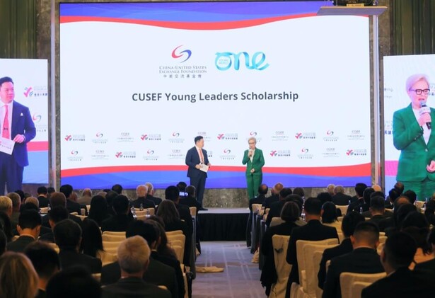 CUSEF Young Leaders Scholarship- James Chau and Kate Robertson presenting on stage in front of audience