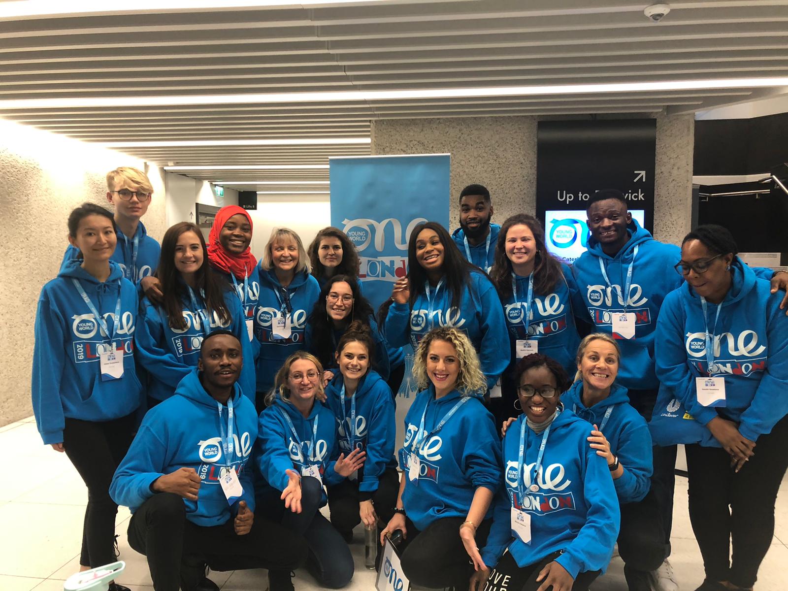 Group photo of One Young World Volunteers wearing branded blue hoodies