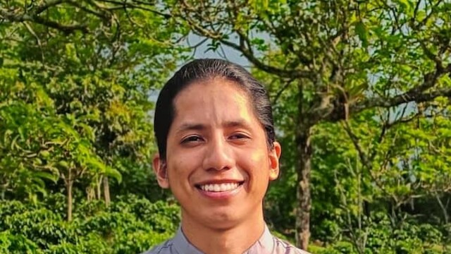 Johan Chavez in white shirt against green bush background