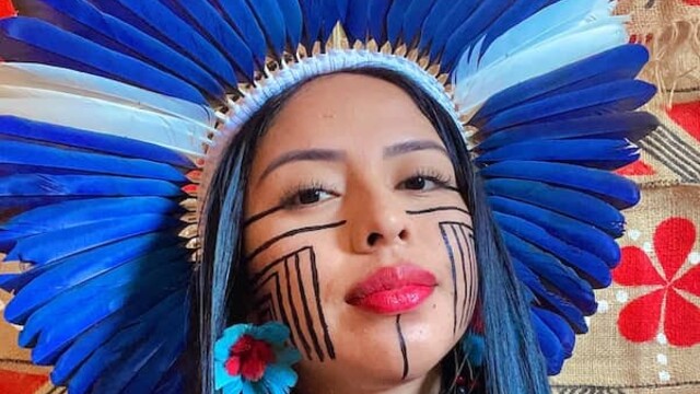 Maricelma Francelino Fialho Cândido wearing Indigenous headwear and face paint