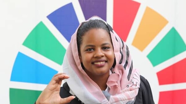 Nisreen Elsaim photo against the a wheel of the UN's SDG colours