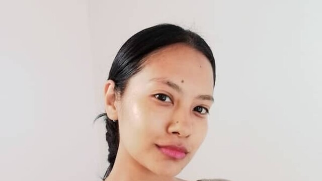 Portrait of Senchhen Hangma Limbu in beige top against beige background