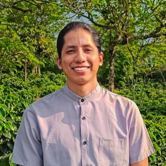 Johan Chavez in white shirt against green bush background