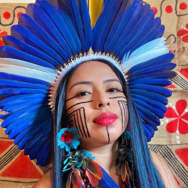 Maricelma Francelino Fialho Cândido wearing Indigenous headwear and face paint