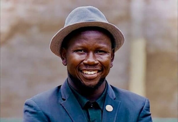 Elihu Jos Benam in dark blue blazer and hat