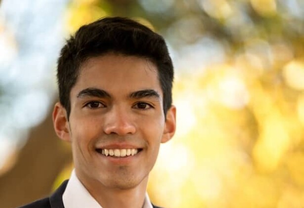 Gabriel Nagel in white shirt and dark blue blazer against blurred outside background