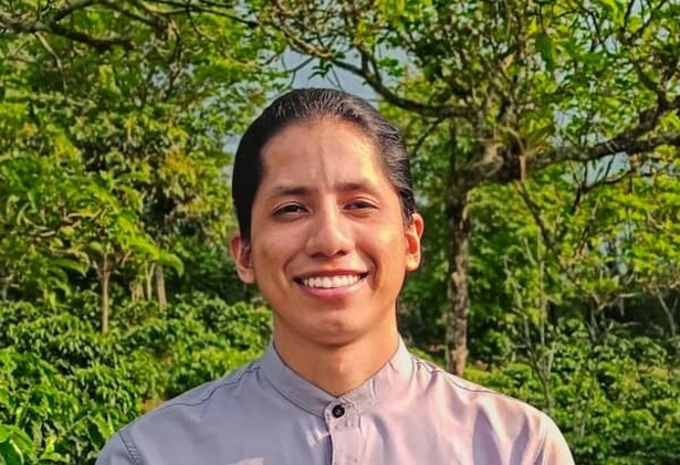 Johan Chavez in white shirt against green bush background